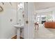 Powder room featuring a pedestal sink, decorative mirror, and convenient access to the living area at 1418 Skidaway Nw St # 427, Concord, NC 28027