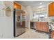 Kitchen with stainless steel appliances, wooden cabinets, and tile floors at 1418 Skidaway Nw St # 427, Concord, NC 28027