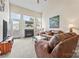 Inviting living room featuring a fireplace, natural light, and neutral carpet throughout at 1418 Skidaway Nw St # 427, Concord, NC 28027