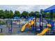 Community playground with colorful slides, climbing structures, and shady umbrellas at 1418 Skidaway Nw St # 427, Concord, NC 28027