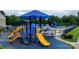 Community playground with colorful slides and pool with lounge chairs in the background at 1418 Skidaway Nw St # 427, Concord, NC 28027