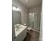 Bright bathroom features a vanity with white counter and a glass-enclosed shower at 145 W Morehouse Ave, Mooresville, NC 28117