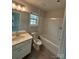 Cozy bathroom featuring a single sink vanity, toilet, and a shower-tub combo at 145 W Morehouse Ave, Mooresville, NC 28117