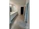 Bright bathroom features a double vanity with framed mirror and a glass-enclosed shower at 145 W Morehouse Ave, Mooresville, NC 28117