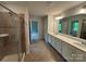 Bright bathroom boasts double sink vanity with modern fixtures and a glass-enclosed shower at 145 W Morehouse Ave, Mooresville, NC 28117