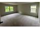 Bedroom features carpeted floors and natural light at 145 W Morehouse Ave, Mooresville, NC 28117