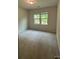 Neutral bedroom with carpeted floors and natural light from the windows at 145 W Morehouse Ave, Mooresville, NC 28117