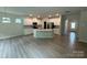 Open-concept kitchen with white cabinetry, stainless steel appliances, and a center island at 145 W Morehouse Ave, Mooresville, NC 28117