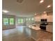 Modern kitchen with white cabinetry, stainless steel appliances, and center island at 145 W Morehouse Ave, Mooresville, NC 28117