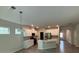 Open-concept kitchen with white cabinetry, stainless steel appliances, and a center island at 145 W Morehouse Ave, Mooresville, NC 28117