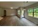 Bright and airy living area with hardwood floors and multiple windows, offering natural light at 145 W Morehouse Ave, Mooresville, NC 28117
