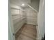 Functional walk-in closet with ample wire shelving and wood-look flooring at 145 W Morehouse Ave, Mooresville, NC 28117