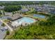 Aerial view of community pool and tennis courts, showcasing the surrounding neighborhood and trees at 14505 Rhodes Hall Dr, Charlotte, NC 28273