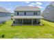 Back of house featuring a covered patio with a brick base, and a view of the spacious backyard at 14505 Rhodes Hall Dr, Charlotte, NC 28273