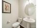 Powder room featuring a pedestal sink, toilet and framed artwork at 14505 Rhodes Hall Dr, Charlotte, NC 28273
