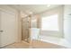 Bathroom boasts a sleek glass-enclosed shower, separate tub, and a window for natural light and ventilation at 14505 Rhodes Hall Dr, Charlotte, NC 28273