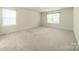 Sunlit bedroom features two windows, plush carpeting, and plenty of space for relaxation and personalization at 14505 Rhodes Hall Dr, Charlotte, NC 28273