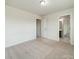 Spacious bedroom features a large window for natural light, neutral carpet, and easy access to bathroom at 14505 Rhodes Hall Dr, Charlotte, NC 28273