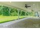Wide angle of covered patio featuring ceiling fans, access to the backyard and natural light at 14505 Rhodes Hall Dr, Charlotte, NC 28273