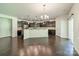 Open kitchen boasts dark cabinetry, stainless steel appliances, and a spacious island with granite countertops at 14505 Rhodes Hall Dr, Charlotte, NC 28273