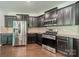 Well-equipped kitchen featuring stainless steel appliances and dark cabinets providing a functional space for cooking and dining at 14505 Rhodes Hall Dr, Charlotte, NC 28273