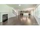 Open concept living room with a fireplace, staircase, and views of the kitchen at 14505 Rhodes Hall Dr, Charlotte, NC 28273
