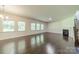 Spacious living room featuring a fireplace, hardwood floors, and staircase at 14505 Rhodes Hall Dr, Charlotte, NC 28273