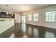 Bright living room featuring hardwood floors, large windows, and access to a patio, perfect for entertaining at 14505 Rhodes Hall Dr, Charlotte, NC 28273