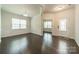 Inviting living room featuring hardwood floors, wainscoting, and a decorative front door at 14505 Rhodes Hall Dr, Charlotte, NC 28273
