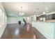 Expansive living room featuring a fireplace, hardwood floors, and an open layout leading to the kitchen at 14505 Rhodes Hall Dr, Charlotte, NC 28273