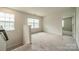 Upstairs loft area with neutral carpeting, natural light, and views of the surrounding neighborhood at 14505 Rhodes Hall Dr, Charlotte, NC 28273