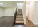 Staircase leading to the upper level, with a view of the living area and a convenient half-bathroom on the ground floor at 14505 Rhodes Hall Dr, Charlotte, NC 28273