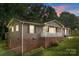 Charming home featuring a brick foundation, inviting front porch, and lush green lawn at 146 Duff St, Gastonia, NC 29715