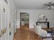 Bright foyer featuring wood floors, white walls, with a view to an updated kitchen at 146 Duff St, Gastonia, NC 29715