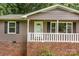 Welcoming home featuring a front door with a glass panel and white railings on the porch at 146 Duff St, Gastonia, NC 29715