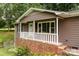 Inviting front porch with white railings and a brick foundation offers a welcoming entrance at 146 Duff St, Gastonia, NC 29715