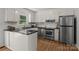 A well-lit kitchen featuring white cabinets, stainless steel appliances, and black countertops at 146 Duff St, Gastonia, NC 29715