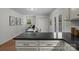 Kitchen featuring black countertops and drawers, that leads to a separate dining area at 146 Duff St, Gastonia, NC 29715