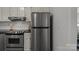 Stainless steel fridge and oven in a kitchen with black countertops and white cabinets at 146 Duff St, Gastonia, NC 29715