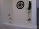 This is a bathtub in bathroom with white tile and a decorative ornament on the wall behind it at 1818 Windy Willow Ln, Dallas, NC 28034
