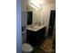 Bathroom features a dual sink vanity, toilet, and adjacent walk-in closet/storage for convenience at 1818 Windy Willow Ln, Dallas, NC 28034