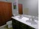 Double sink vanity in a bathroom with framed art and patterned shower curtain at 1818 Windy Willow Ln, Dallas, NC 28034