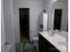 Bathroom features a dual sink vanity, toilet, and adjacent walk-in closet/storage for convenience at 1818 Windy Willow Ln, Dallas, NC 28034