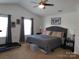 This is a neutral primary bedroom with a comfortable bed, ceiling fan, and window for natural light at 1818 Windy Willow Ln, Dallas, NC 28034