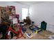Bedroom featuring books, exercise bike, sewing table, and other items at 1818 Windy Willow Ln, Dallas, NC 28034