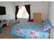 Comfortable bedroom features a floral patterned bed, TV, dresser, and window for natural light at 1818 Windy Willow Ln, Dallas, NC 28034