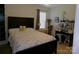 Bright bedroom features a bed with colorful floral quilt, desk area, and decorative shelf with plants at 1818 Windy Willow Ln, Dallas, NC 28034