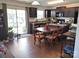 Eat-in kitchen features dark wood cabinetry, modern appliances, and wood floors at 1818 Windy Willow Ln, Dallas, NC 28034