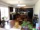 Kitchen featuring modern appliances, dark wood cabinetry, and wood floors at 1818 Windy Willow Ln, Dallas, NC 28034