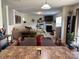 Open-concept living space with fireplace, neutral décor, and wood floors at 1818 Windy Willow Ln, Dallas, NC 28034
